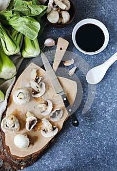 Preparing for chinese meal. Cooking Ingredients: bok choy, mushrooms, garlic and soy sauce in bowl.