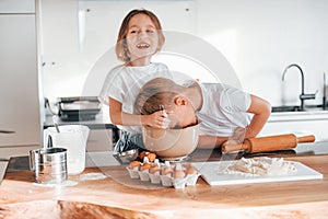 Preparing Christmas cookies. Little boy and girl on the kitchen