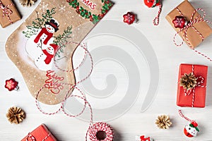 Preparing for Christmas - presents and decorations on a white wooden table. Mockup for advertisements and Christmas