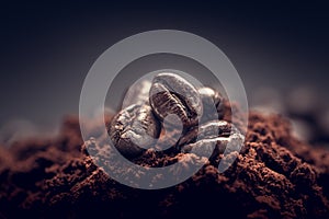 Preparing coffee close up. Coffee beans on a pile of ground coffee.