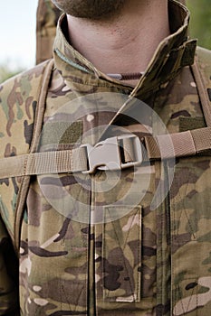 Preparing for Combat: Close-up of Soldier Putting on Gear in the Field before fight