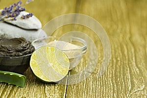 Preparing cosmetic mud mask with aloe vera, lime, lavender, essential oil. facial clay with spa products stones. Natural