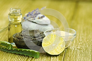 Preparing cosmetic mud mask with aloe vera, lime, lavender, essential oil. facial clay with spa products stones. Natural