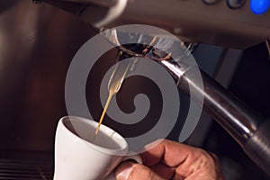 Preparing cup of coffee with coffee machine, background for coffee shop or barista, cup of coffee prepare only hands