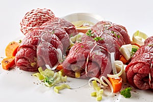 Preparing a dish of fresh beef roulades