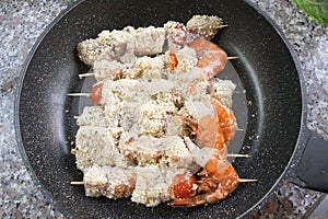 Preparing fish skewers