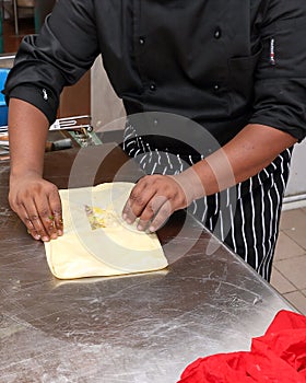 Preparing folding Mughlai paratha