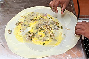 Preparing folding Mughlai paratha