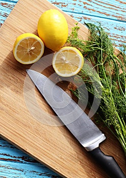 Preparing food for sauce salad by ingredient is lemon and coriander on wood block