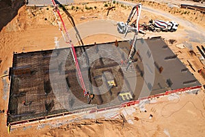 Preparing Formwork for First Floor Slab at construction. Formworks and pouring concrete. oncrete pump truck connected to concrete