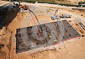 Preparing Formwork for First Floor Slab at construction. Formworks and pouring concrete. oncrete pump truck connected to concrete