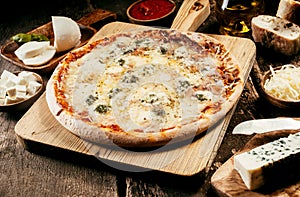 Preparing a four cheeses Italian pizza