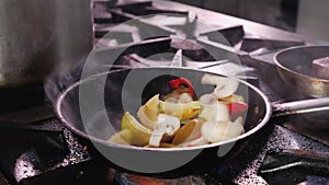 Preparing fried vegetables, tossing the pan - close up