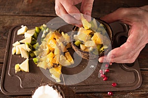 Preparing of fruit salad in coconut shell