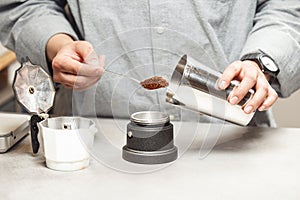 Preparing Geyser Coffee Maker by Filling Cup With Freshly Ground Medium Coffee