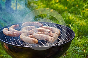 Preparing Grilled Sausages Outdoors