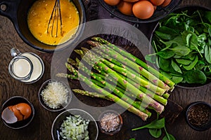 Preparing healthy asparagus and spinach omelet or frittata with ingredients photo