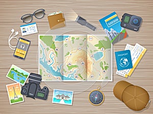 Preparing for hiking tour, vacation, travel. Planning, packing check list. Wooden table with tourist map, guidebook, tickets photo