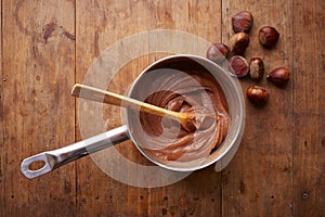 Preparing homemade chestnut cream on a pot