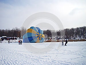 Preparing hot air balloon for morning flight. Man inside big bright hot air balloon preparing it for aeronautic competition. Lot