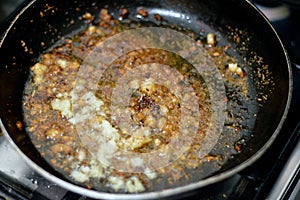 preparing the last step of the popular Egyptian Molokhiya soup making Taqliya Takliya which is frying minced garlic in ghee with