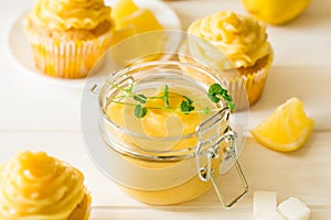 Preparing lemon cupcakes with citrus curd