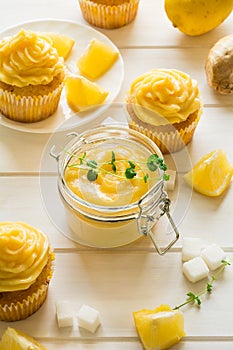 Preparing lemon cupcakes with citrus curd