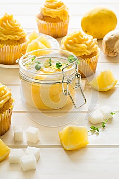 Preparing lemon cupcakes with citrus curd