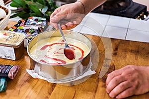 Preparing lemon curd cheesecake with strawberries photo