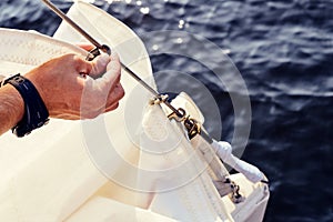 Preparing before lifting staysail sails.