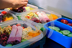 Preparing meal in plastic containers