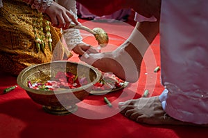 Preparing for Ngidak tagan or Nincak ndog, the ritual of stepping on raw chicken eggs by the groom at a traditional Javanese weddi