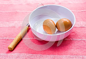 Preparing omelet with eggs and whisk