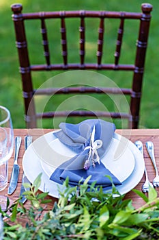 Preparing for an open-air party. Decorated with fresh flowers served tables. Table number. Decoration Details