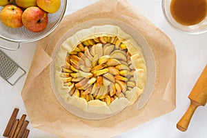 Preparing open pie or galette with apples
