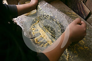 Preparing Peruvian yellow chili, also called aji amarillo sauce with a fulling mill in the city of Cusco in Peru. photo
