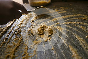 Preparing Peruvian yellow chili, also called aji amarillo sauce with a fulling mill in the city of Cusco in Peru. photo