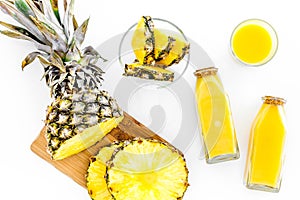 Preparing pineapple juice. Cut slices of pineapple. White background top view