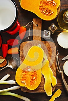 Preparing pumpkin, onions and sweet peppers for cooking