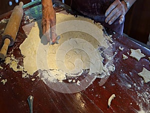 Preparing raw dough for christmas tarts