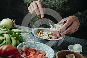 preparing a salad from andalusia with broad beans photo