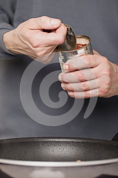 Preparing sauce with meat for spaghetti with pork and beef, tomato and cheese