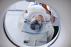 Preparing for the scan. Shot of a senior woman being comforted by a doctor before and MRI scan.