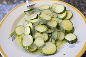 Preparing sliced zucchini au gratin