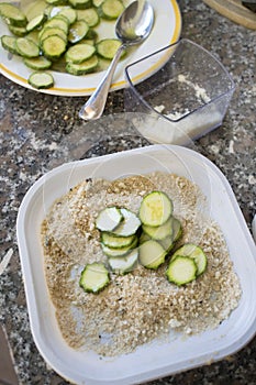 Preparing sliced zucchini au gratin