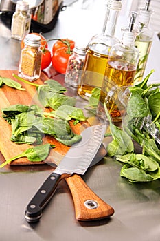 Preparing spinach leaves on cutting board