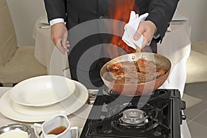 Preparing steak flamb on a carving table