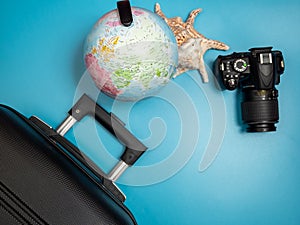 Preparing for summer holidays: travel suitcase, globe and digital camera, travel and tourism concept