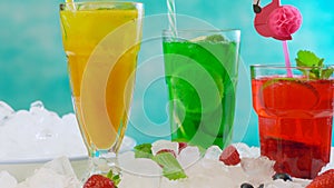 Preparing Summertime Spritzer drinks with fruit and sparkling mineral water.