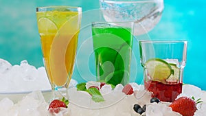 Preparing Summertime Spritzer drinks with fruit and sparkling mineral water.